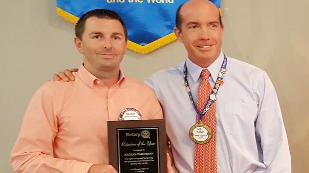 Nathan Parchman, left, was named Rotarian of the Year. Outgoing president Lex White, right, presented the award.