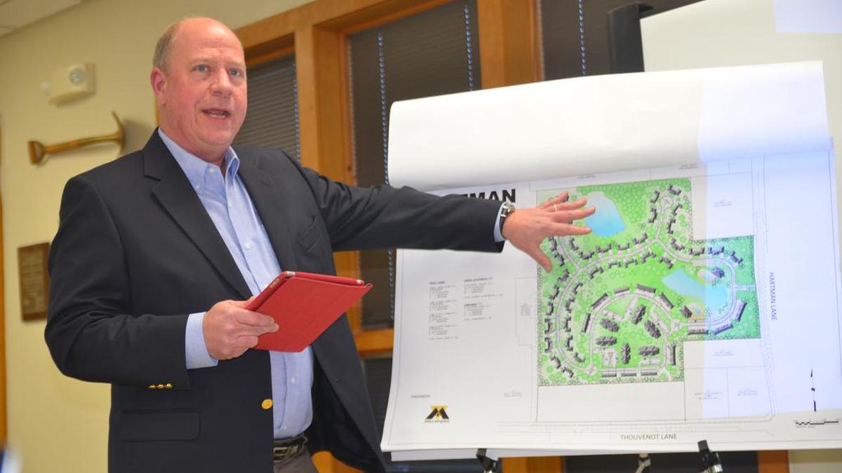 Eric Olson, of Millennia Professional Services of Illinois Ltd., presents diagrams of the proposed Hartman Lakes development to the Board of Trustees Monday night.