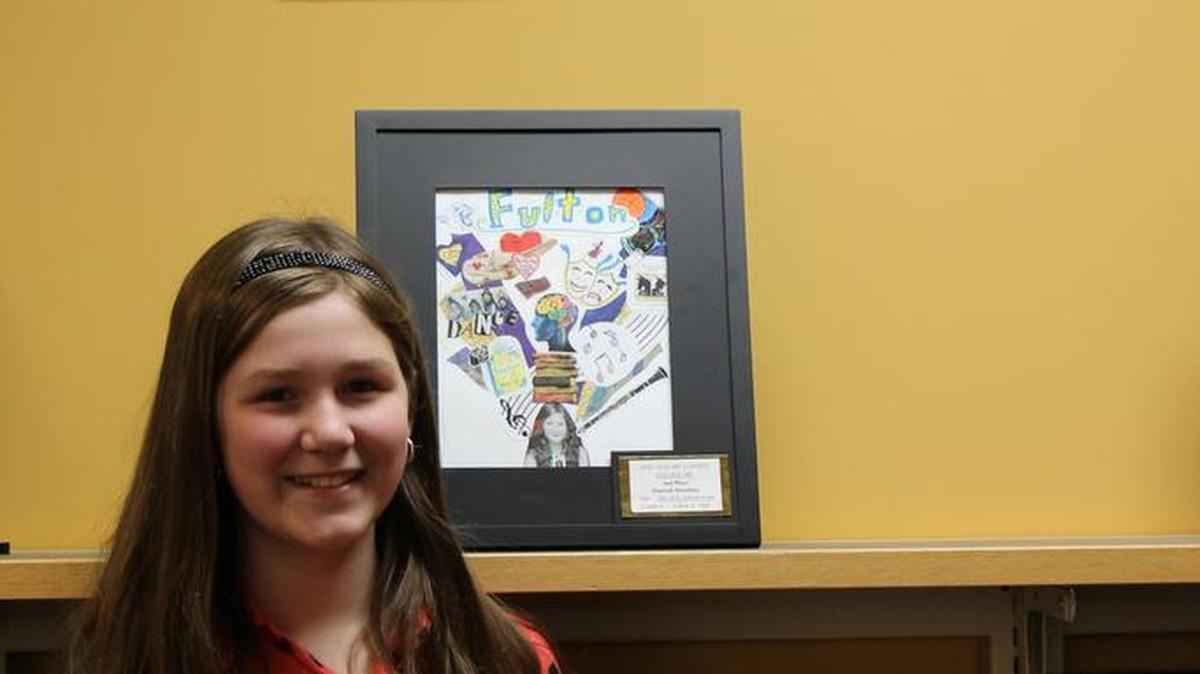 Hannah Donahue, a sixth grade student at Fulton Jr. High stands with her art piece titled “The Only School 4 Me.” Hannah, whose work tied for second place was one of three prize winners in the O’Fallon Woman’s Club 2016 Art Contest.