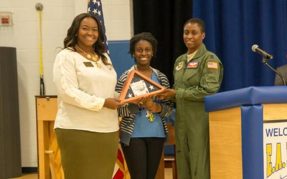 A flag was presented to Captain Nicola Morrison, the mother of seventh-grader T’Keyah Quarrie, during an assembly at Fulton Junior High.