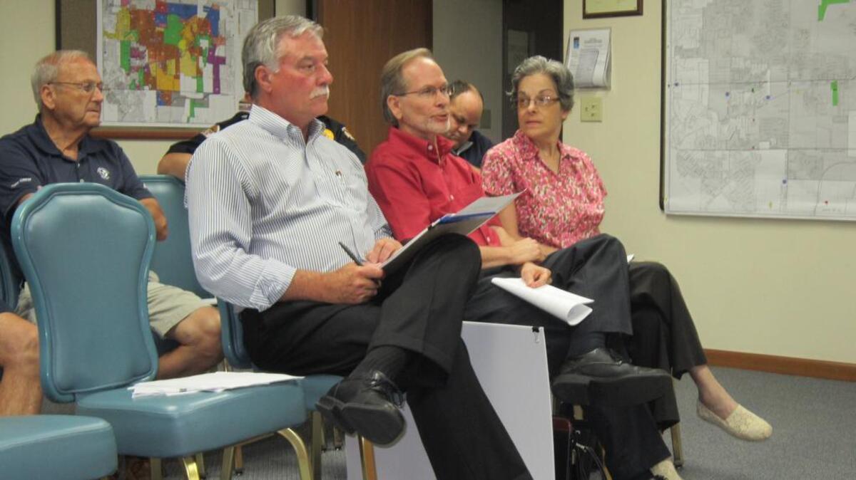 From left, Village Administrator John Marquart; U Studios Inc. Architect Gary Karasek and his sister Carolyn during Monday’s (Aug. 23) Committee at Large meeting.