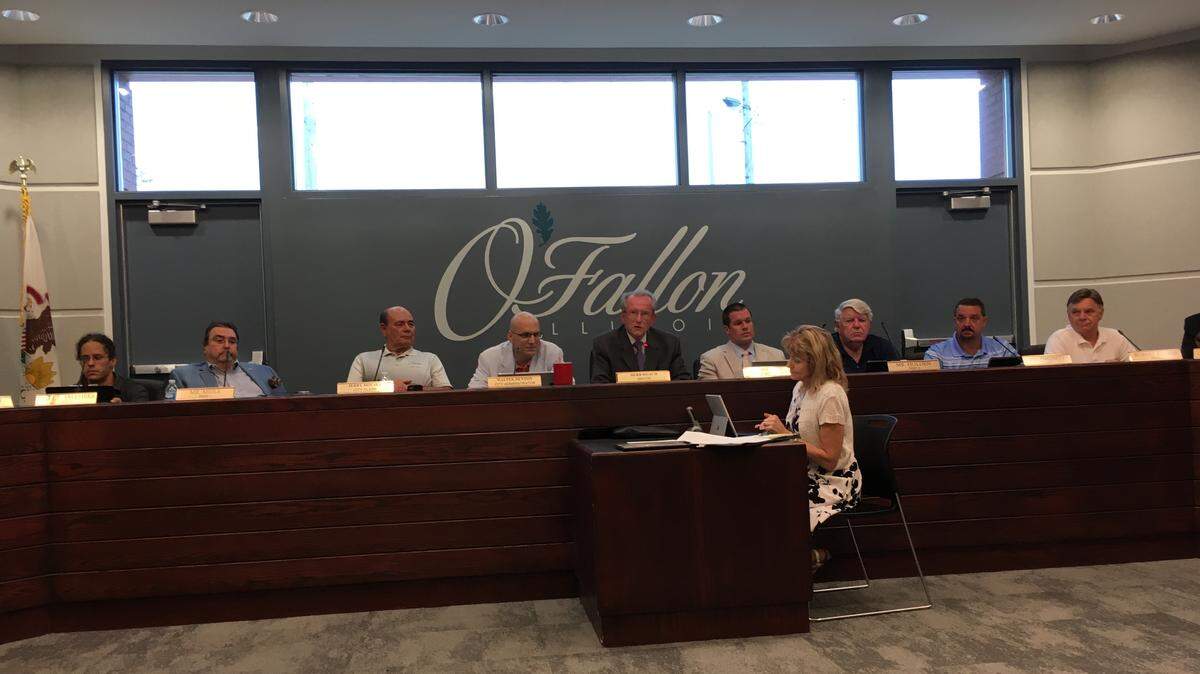 Mayor Herb Roach addresses the O’Fallon City Council Chambers against a new backdrop that includes escape doors for added security.