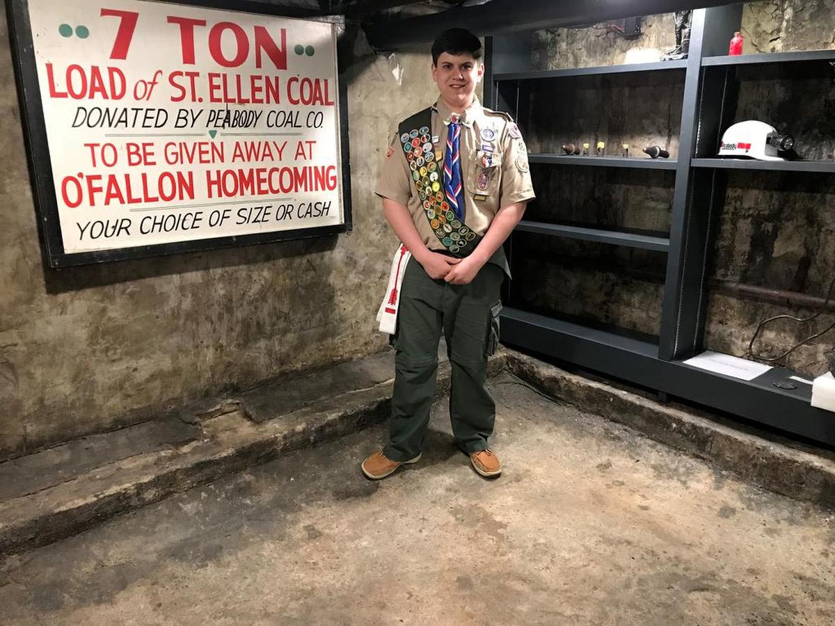 Tommy Fulford stands in front of shelves with coal mine artifacts inside his recently finished O’Fallon History Museum Coal Mine Exhibit he worked on over the course of nearly two years for his Boy Scouts of America Eagle Scout Award, which he received Jan. 28, 2018.