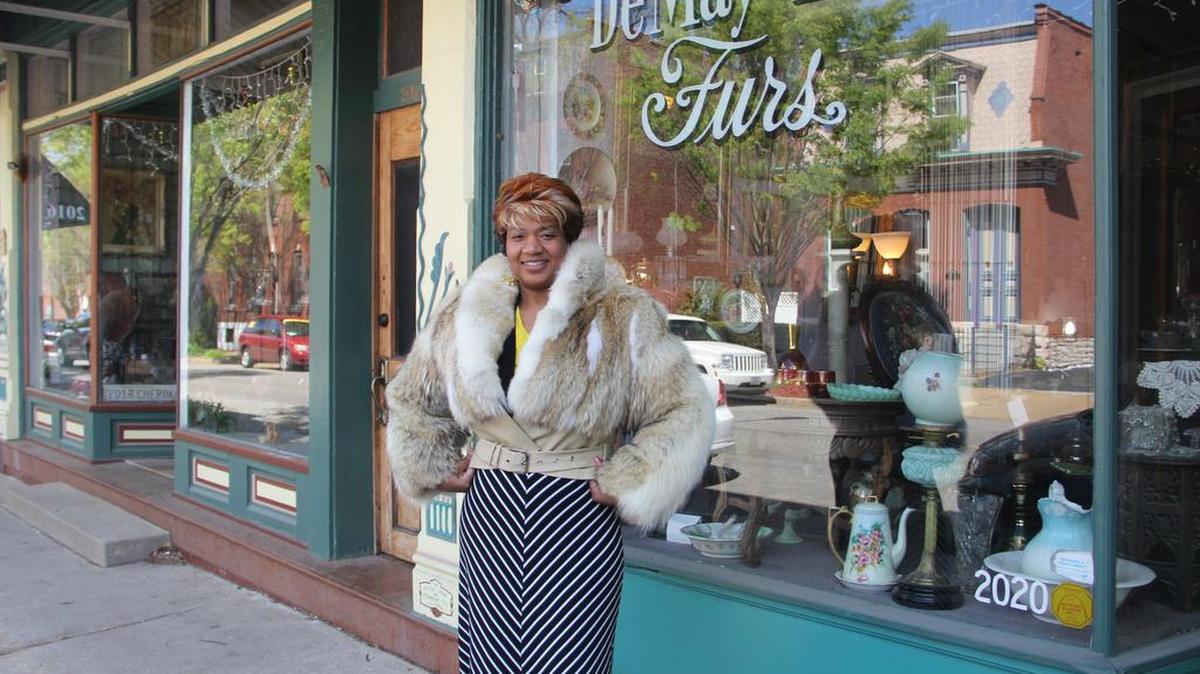 Jackie Jackson models a fur coat for sale DeMay Ltd. at 2020 Cherokee St. in St. Louis. Shirley DeMay owns the furrier store, which also sells antiques.