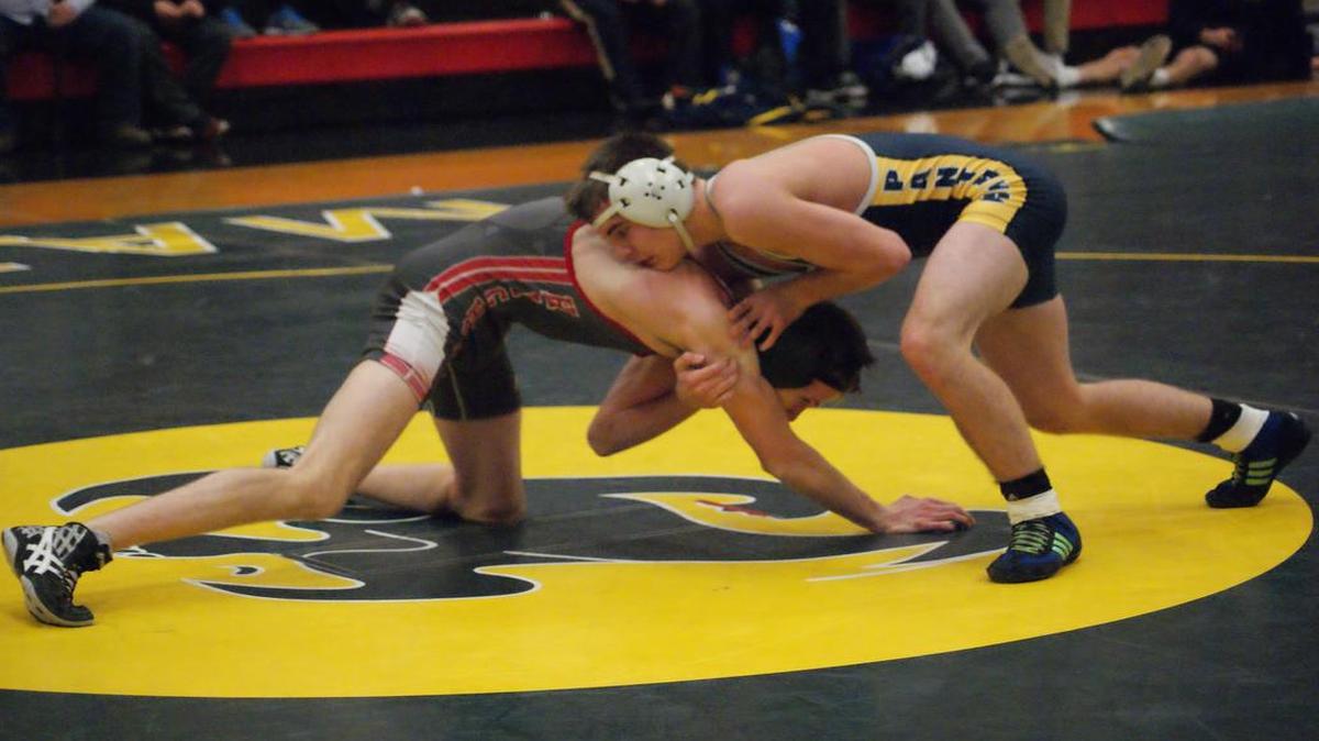 O’Fallon wrestler Alex Fulton works to get the upper hand on Highland’s Jacob Mitchell during their 132-pound match Dec. 13 at Highland High School. Fulton ended up winning the hard-fought match 6-2 over Mitchell.
