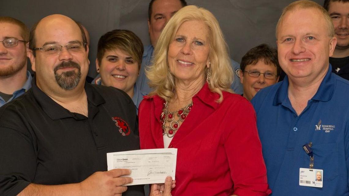 Debbie Braun, center, presents SWIC Paramedic Program Coordinator Curt Schmittling, left, and Paramedic Instructor Jay Johns, right, with a check worth $9,400 to enhance the college EMS Skills Lab and curriculum.