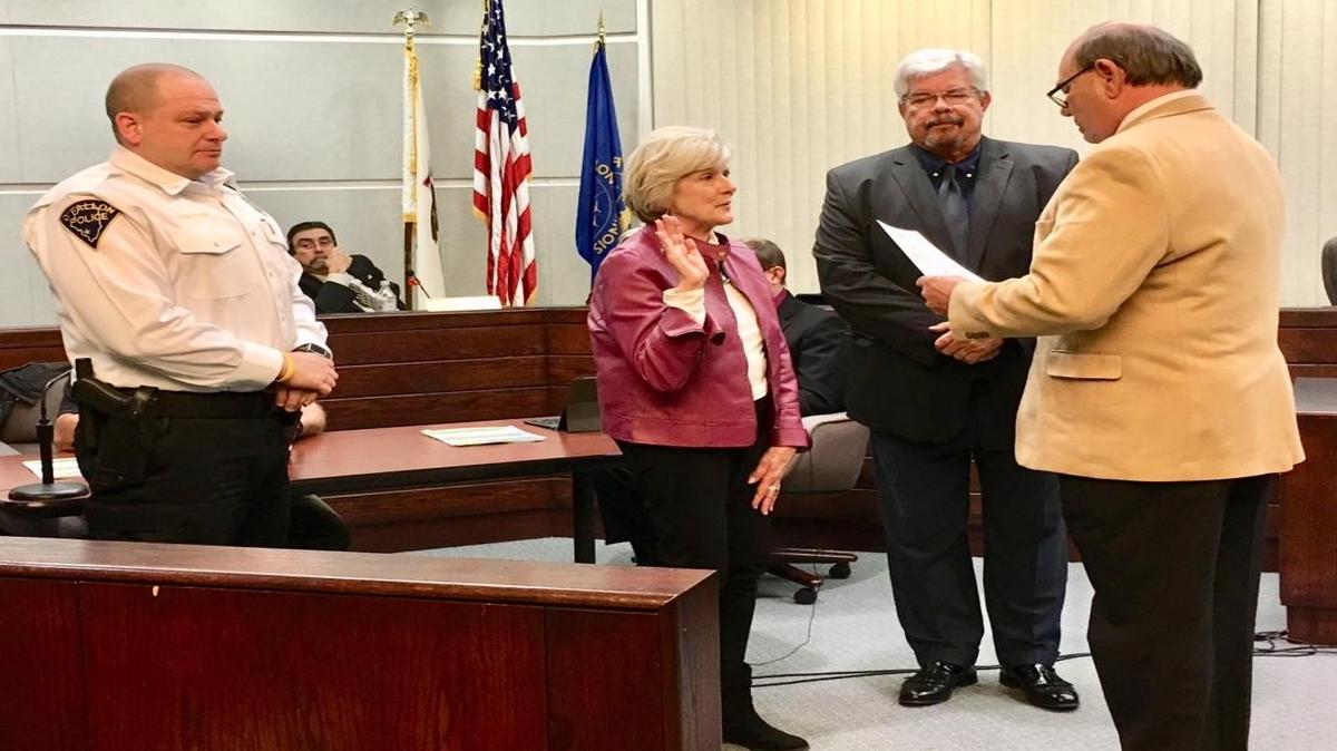 Susan Holden and Scott Battoe were sworn is as the newest Commissioners on the Police and Fire Board during Monday night's council meeting. City Clerk Jerry Mouser administered the oath while Police Chief Eric Van Hook and Mayor Herb Roach look on.