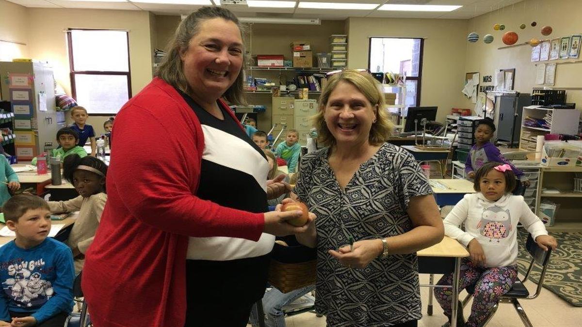 From left, Beth Lundy, president of the O’Fallon Woman’s Club, presents Michelle Hamby, second-grade teacher at Marie Schaefer Elementary, with an “Apple for Teachers.” For the past 45 years, the club has acknowledged the service and dedication of O’Fallon’s educators to the children of community. Woman’s Club members visited all schools and hand-delivered apples to teachers and support staff last month. “We’ve been doing this for many years, and both the teachers and club members look forward to it each year. The club buys the apples, and the members gather and distribute them throughout the schools. We walk into each classroom, hand the teacher, aide, intern, etc., an apple and personally thank them for their commitment to our children,” said Margo Snyder of the O’Fallon Woman’s Club. The club typically hands out the American Education Week in November. “When we first started showing appreciation 45 years ago, I think members made pencil holders for teachers, and there may have been other simple gifts provided in subsequent years, but in the past 16 years that I’ve been a member, we have delivered apples,” Snyder said.