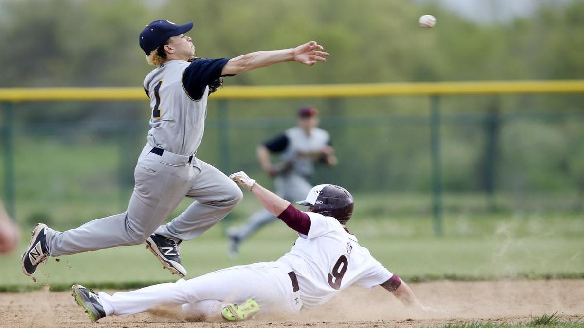 Belleville West’s Austin Guetterman breaks up the double play as O’Fallon second baseman Josh Gibson throws to first during a game last season.