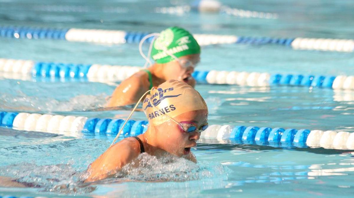 Rachel Barnes edges ahead in the 9-10 girls 25-meter breast. Barnes won the event and the Breakers won the meet 366-164.
