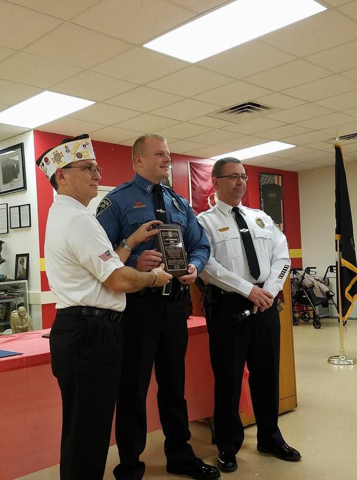 O’Fallon Veterans of Foreign Wars Post 805 Commander Ed Martinez awards O’Fallon Police Officer Clay Hoff with the VFW National Law Enforcement Public Service Citation Award during the annual VFW First Responder Award Banquet. O’Fallon Police Lt. Rob Schmidtke stands far right.