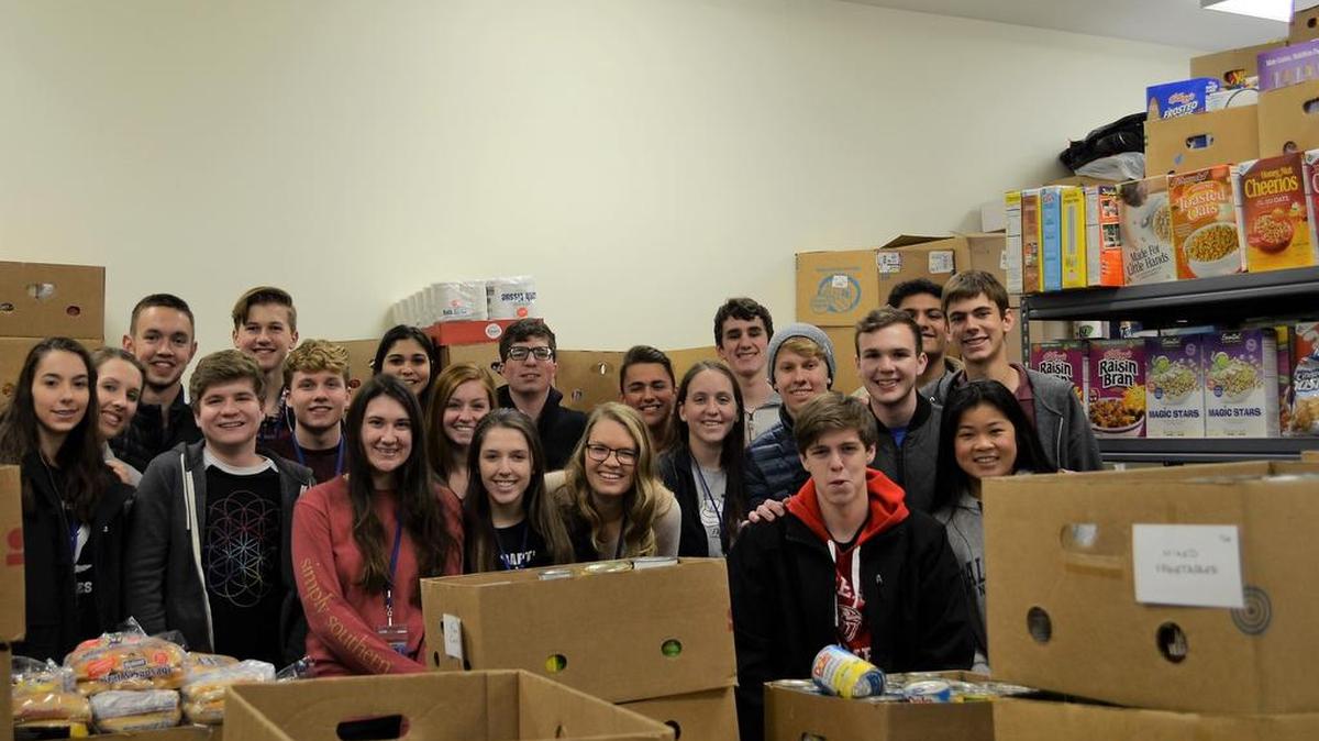 At the O’Fallon Food Pantry, the First Baptist Academy National Honor Society and Student Council stand with Food Pantry volunteers when the students dropped off donations they purchased at Schnucks in O’Fallon. In total students raised around $1,600 between odd jobs at home and a fifth grade bake sale.