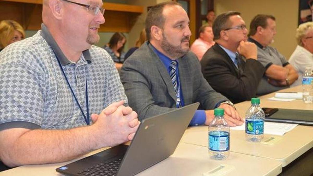 Left, O’Fallon District 104 Superintendent John Bute sits during a BASSC meeting last summer.