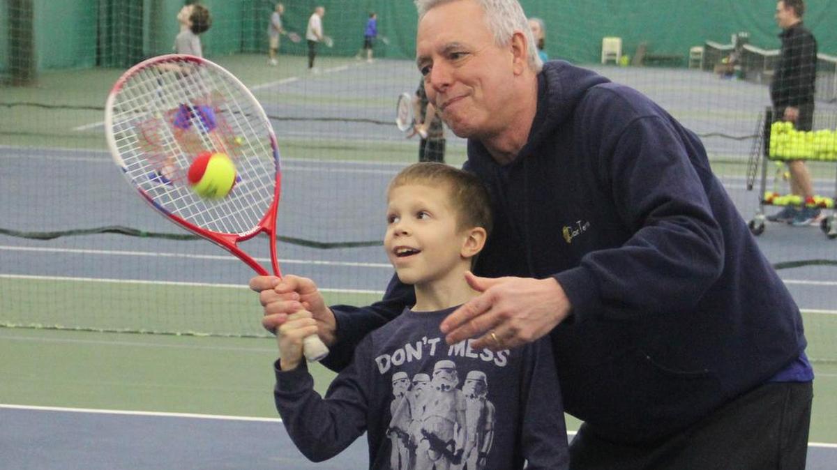 Mark Brunner gives seven-year-old Parker Warfield of O’Fallon a tennis lesson at St. Clair Tennis Club. Mark and his wife, Naomi, have owned the tennis club in O’Fallon since August 2007.