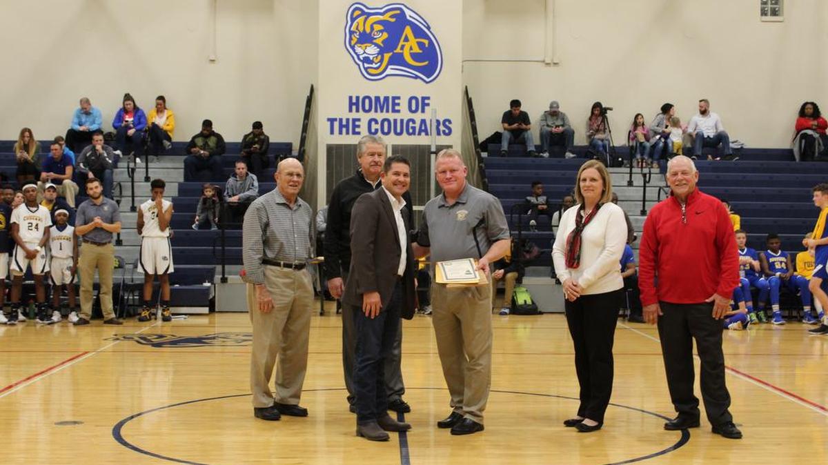 Carriel Junior High athletic director Tracy Lauderdale, center, receives the Coaching Longevity Award. Lauderdale is stepping down as the baseball coach at Carriel.