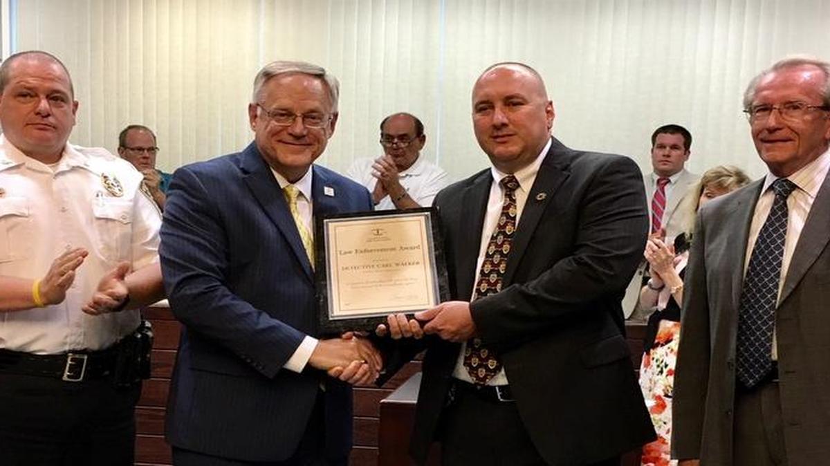From left, O’Fallon Director of Public Safety Eric Van Hook, Illinois State Bar Association third vice president Dennis Orsey, O’Fallon Police Department Detective Carl Walker and O’Fallon Mayor Herb Roach as Walker receives an award from the ISBA. Pancreatic cancer, diagnosed in 2019, led to Walker’s death at age 50 on Jan. 13. His colleagues and the community paid tribute to him as a person and for his many achievements.