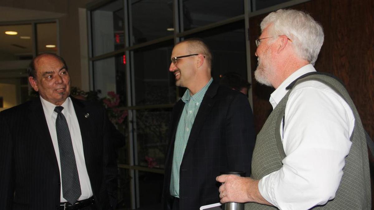Ward 3 Alderman Jerry Mouser visits with City Administrator Walter Denton and Community Development Director Ted Shekell after Monday’s City Council meeting. Mouser announced earlier in the night he is resigning.