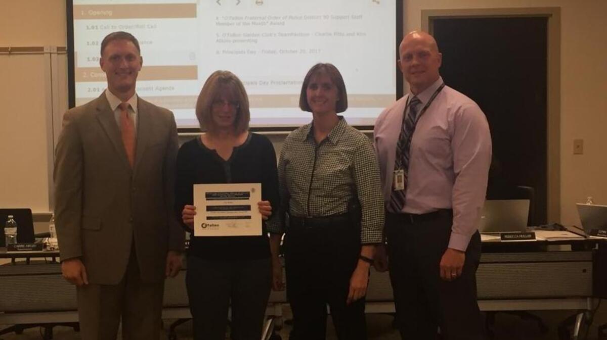 From left, O’Fallon School District 90 Board of Education president John Wagnon; October O’Fallon District 90 Staff Member of the Month Terri Gunter, Hinchcliffe aid; and, O’Fallon Fraternal Order of Police representatives Kathleen Effan and Mark Berry.