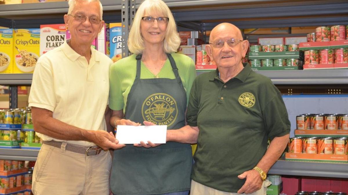 From left, Roy Carlson, chairman Pete MacLaughlin Golf tourney, delivers a check for $7,132 from the fundraiser, to O’Fallon Food Pantry volunteers Patty Strube and Ron Dormer.
