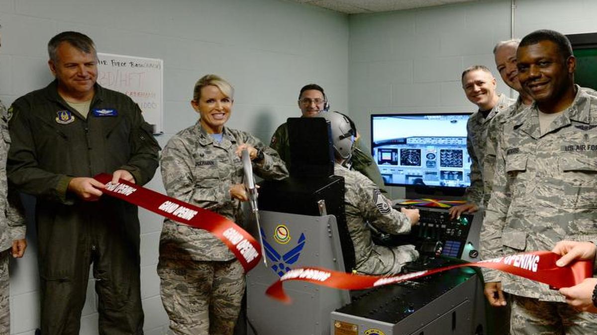 Col. Laura Lenderman, 375th Air Mobility Wing commander cuts a ribbon to present the Reduced Oxygen Breathing Device at Scott. The ROBD allows aviators and aircrew to experience hypoxia without the threat of decompression sickness or the need for preoxygenation. Over the next six years, the ROBD will save Scott AFB over $300,000 in training.