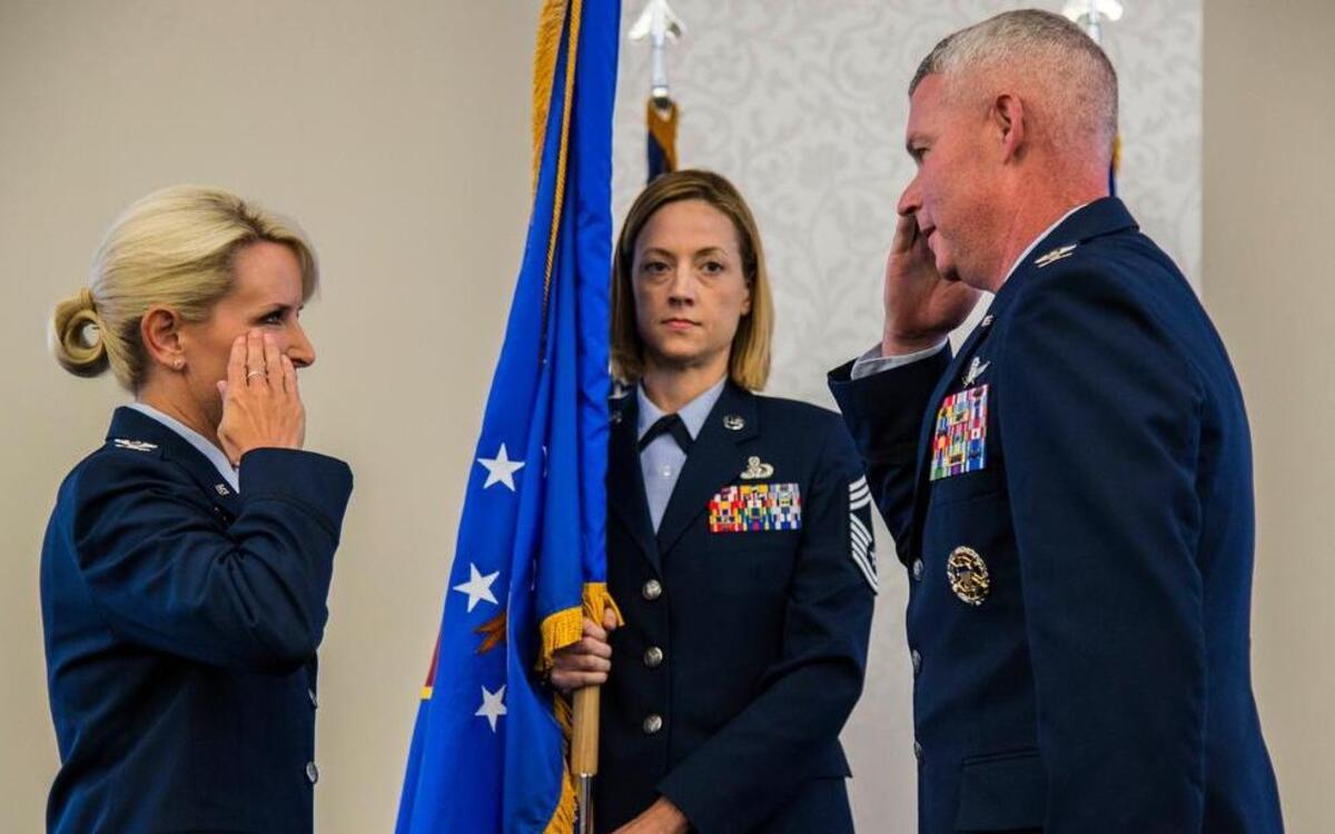 Col. Laura Lenderman, 375th Air Mobility Wing commander, salutes Col. Marc Packler after passing the guidon to him signifying the beginning of his tenure as the 375th Communications Group commander during a change of command ceremony June 15 at Scott AFB. The 375th Communications Group supports the mission of the 375th AMW in its global reach mission by providing command, control, communications and computer support to Department of Defense, USTRANSCOM, Air Mobility Command, 18th Air Force, Military Surface Deployment and Distribution Command, Air Force Network Integration Center, three flying wings, 31 mission partners and direct support to the 618th Air Operations Center (Tanker Airlift Control Center) global mission.