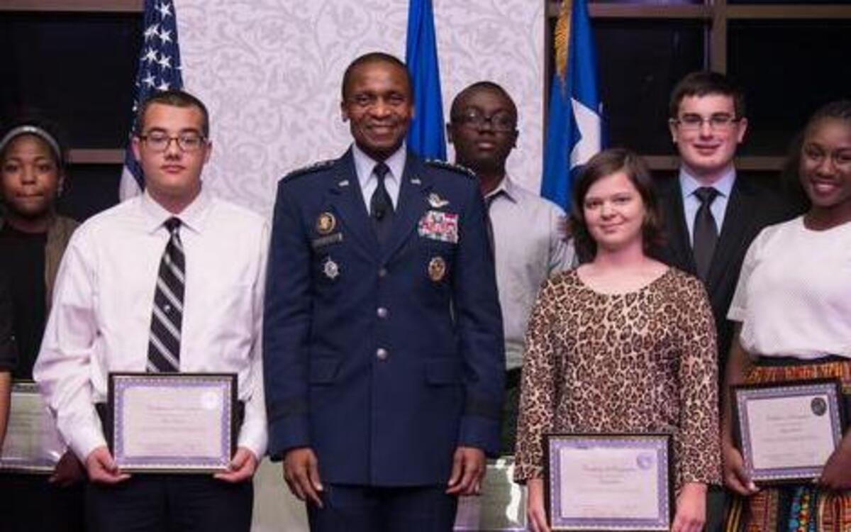 General Darren McDew, U.S. Transportation Command commander, presents certificates to students on behalf of the Midwest Cyber Center of Excellence at the Inaugural Cyber Security Awareness Banquet on Oct. 6 in honor of National Cyber Security Awareness Month. The certificates were presented for their dedication and excellence in pursuit of science, technology, engineering and mathematics activities. This year’s banquet theme was “Leveraging our past and our partnerships to develop cyberspace professionals today and tomorrow.” For more photos from the event, visit www.scott.af.mil.