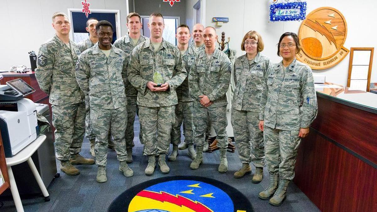 Staff Sgt. Eric Dudley (center), 38th Cyberspace Readiness Squadron, is this quarter’s winner of the Diamond Sharp Award.