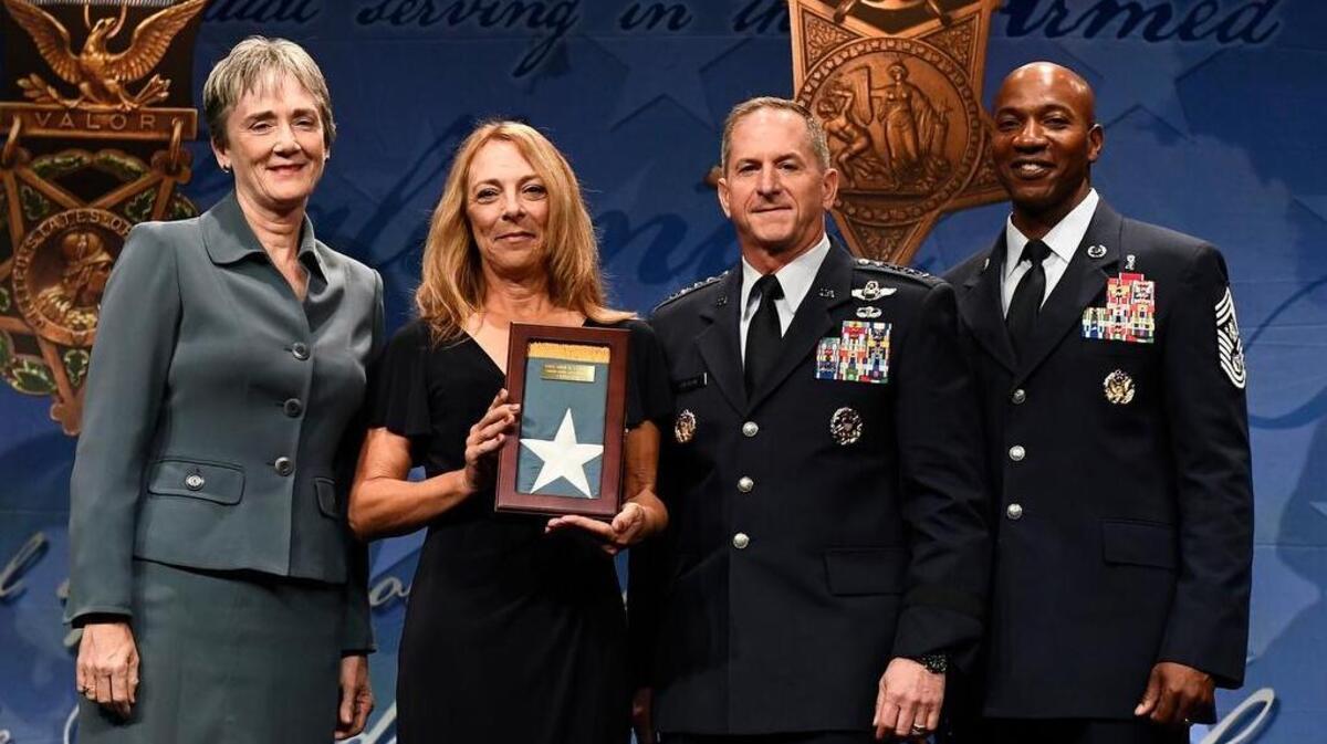Secretary of the Air Force Heather A. Wilson; Gen. David L. Goldfein, Air Force Chief of Staff; and Chief Master Sgt. of the Air Force Kaleth O. Wright present the Medal of Honor Flag to Valerie Nessel, widow of Medal of Honor recipient Tech. Sgt. John Chapman, during Chapman’s Pentagon Hall of Heroes induction ceremony Aug. 23 at the Pentagon, in Arlington, Virginia. Photo by Staff Sgt. Rusty Frank