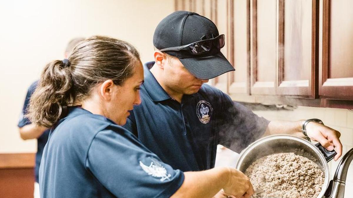 The Scott Air Force Base First Sergeant’s Group prepares a meal for dorm residents. The meals are prepared as part of the Dorm Dinner program, which provides dorm residents a home cooked meal and a chance to interact with different organizations on base.