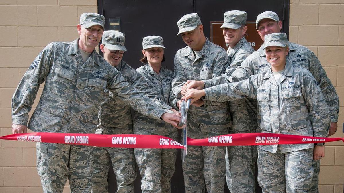 Col. Leslie Maher, 375th Air Mobility Wing commander, and the official party cut the ribbon at the Rockwell hall grand opening ceremony June 20 at Scott Air Force Base. Minutes after the ribbon was cut, the first professional development course was held in the hall.