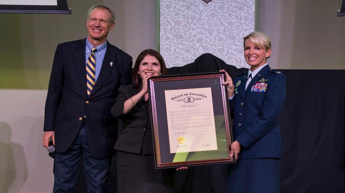 Illinois Gov. Bruce Rauner joins Ill. Lt. Gov. Evelyn Sanguinetti and Col. Laura Lenderman on stage as he presents a proclamation declaring 2017 as the “Year of Scott Air Force Base.” Rauner thanked the servicemembers and congratulated Scott communities who have supported them and their families for the past century. Lenderman serves as the 375th Air Mobility Wing commander and the Scott AFB Installation commander.