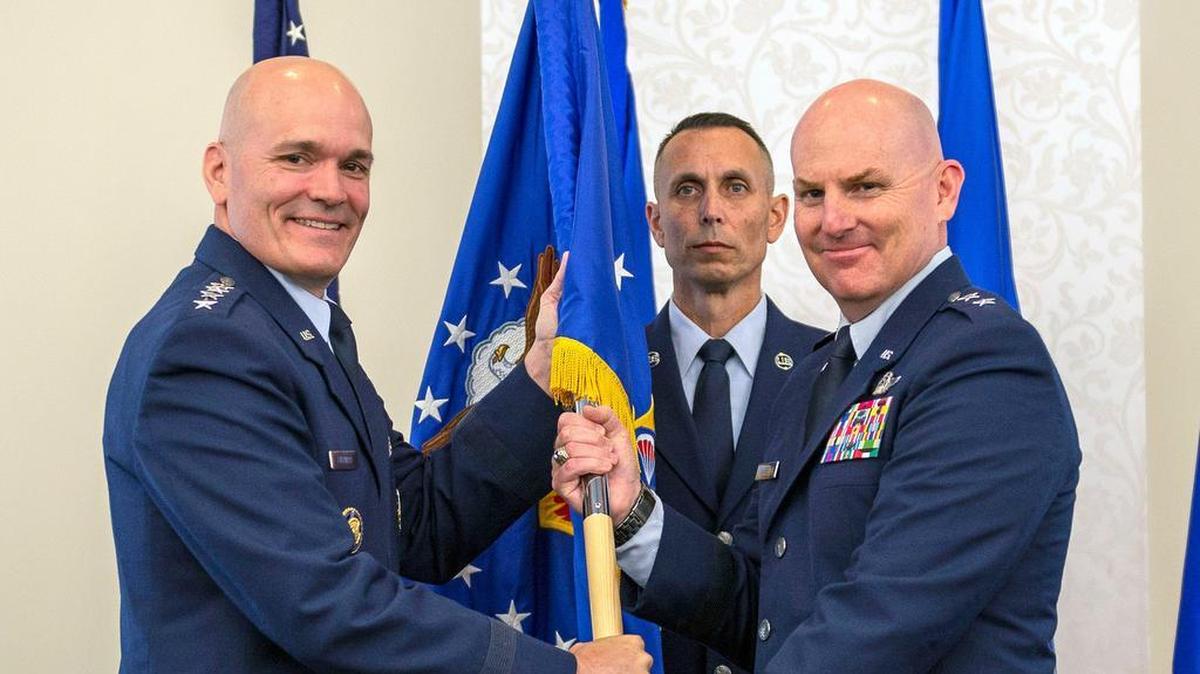 Gen. Carlton D. Everhart II, Air Mobility Command commander, passes the 18th Air Force guidon to Maj. Gen. Sam C. Barrett during a change of command ceremony July 31 at Scott Air Force Base. Barrett comes to 18th AF from his position as the Director of operations, Strategic Deterrence and Nuclear Integration, Headquarters Air Mobility Command, Scott AFB. Photo by Airman 1st Class Chad Gorecki