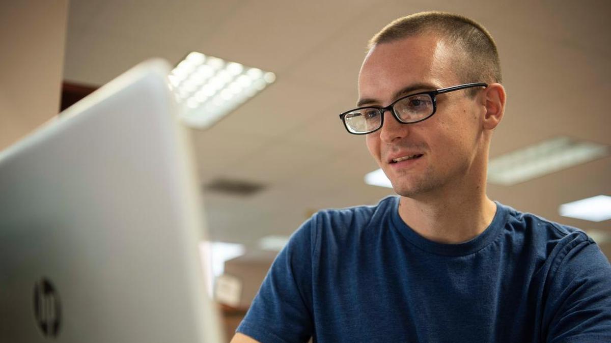 Staff Sgt. Christopher Povlich, 375th Communication Support Squadron, fixes a computer during Cyberfix at the Scott Air Force Base Library. Cyberfix is a free program for those with base access to get “tech items” fixed, such as computers, tablets and phones. Photo by Senior Airman Melissa Estevez