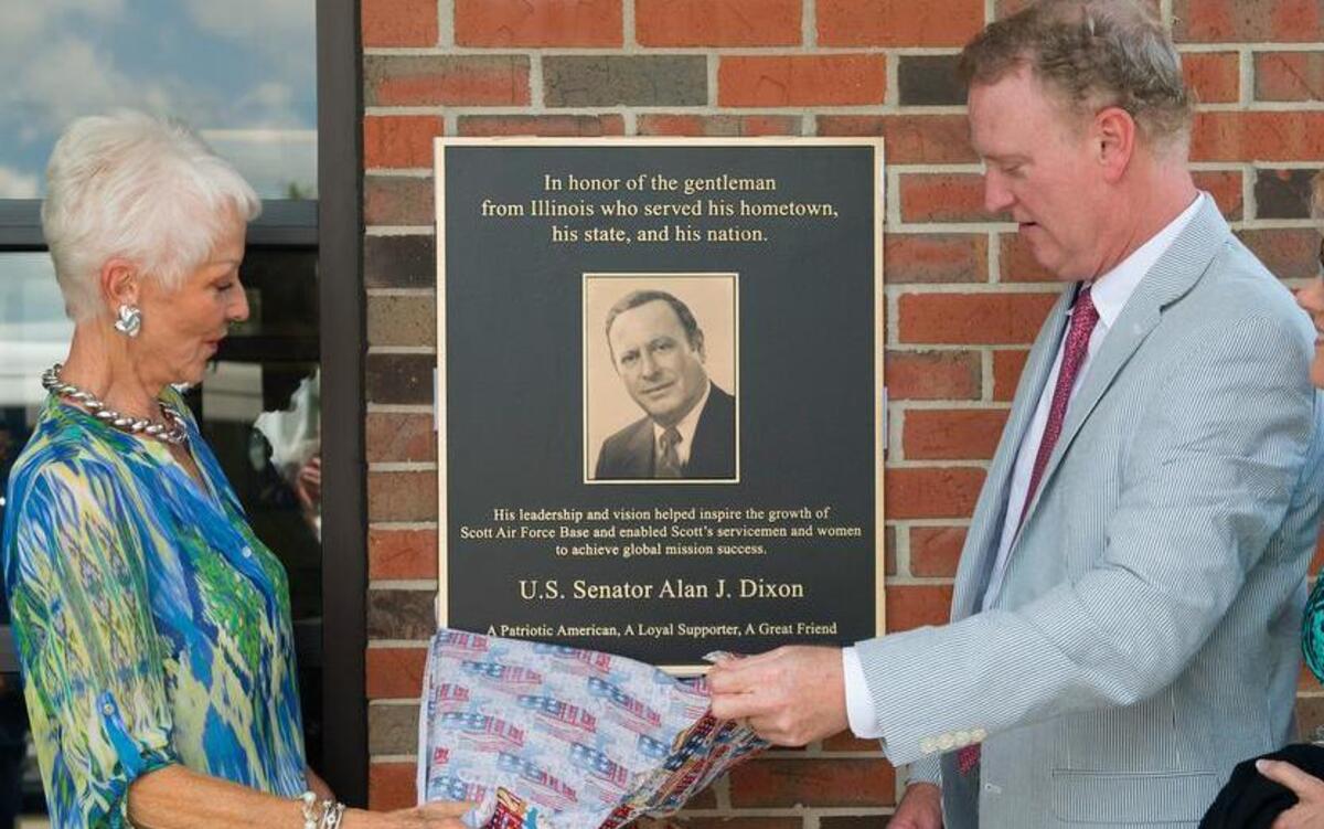 U.S. Sen. Alan J. Dixon’s wife, Jody, and son, Jeff, unveil a plaque during a dedication ceremony July 8 at the Visitor Control Center at Scott Air Force Base. The visitor center was dedicated to the late Dixon, who gave 43 years of public service to Scott AFB and the state of Illinois.