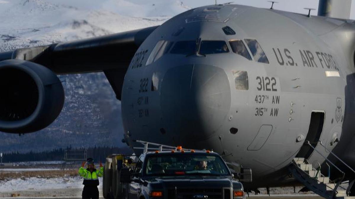 Jeffrey Zook, 732nd Air Mobility Squadron fleet services vehicle operator, guides one of the latrine servicing trucks safely toward a C-17 Globemaster III at Joint Base Elmendorf-Richardson in Alaska. Fleet services ensures all aircraft, regardless of origin, are clean and serviceable for aircrews and passengers.