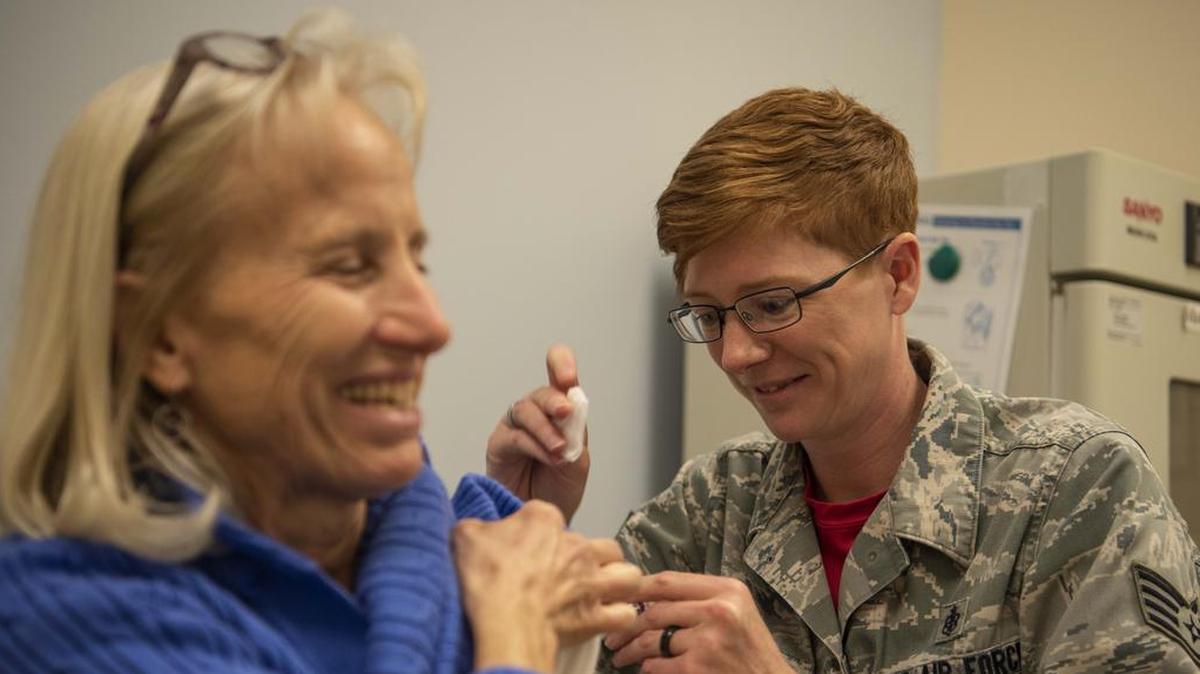 Staff Sgt. Kelly Davis, 375th Medical Operations Squadron immunization back-up technician, vaccinates a patient at the Scott Medical Clinic. The Scott Immunizations Clinic offers vaccine services for active duty, retirees and family members to include deployment and travel vaccines. Walk-in services are provided during normal business hours for routine vaccines. Yellow Fever and Smallpox are offered by appointment only. Photo by Senior Airman Melissa Estevez