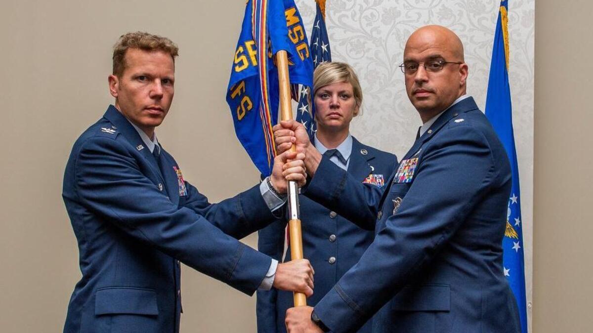Col. Robert Henderson, 375th Mission Support Group commander, presents the 375th Security Forces Squadron guidon to Lt. Col. Yon Dugger during a change of command ceremony July 6 at Scott Air Force Base. Dugger comes to Scott from the Pentagon in Arlington, Virginia.