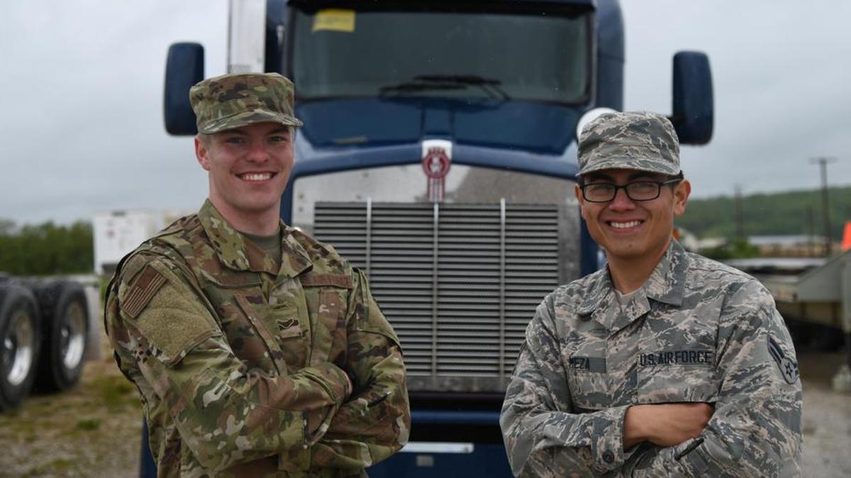 Airman 1st Class Mason Hedrick, 509th Logistics Readiness Squadron, Whiteman Air Force Base, Missouri, ground transportation, left, and Airman 1st Class Ricardo Meza, 368th Training Squadron, Fort Leonard Wood, Missouri, student, smile for a photo during the 3rd Annual Ground Transportation Rodeo at Fort Leonard Wood. Meza and Hedrick used the opportunity exchange stories of the things they have seen and done in their careers.