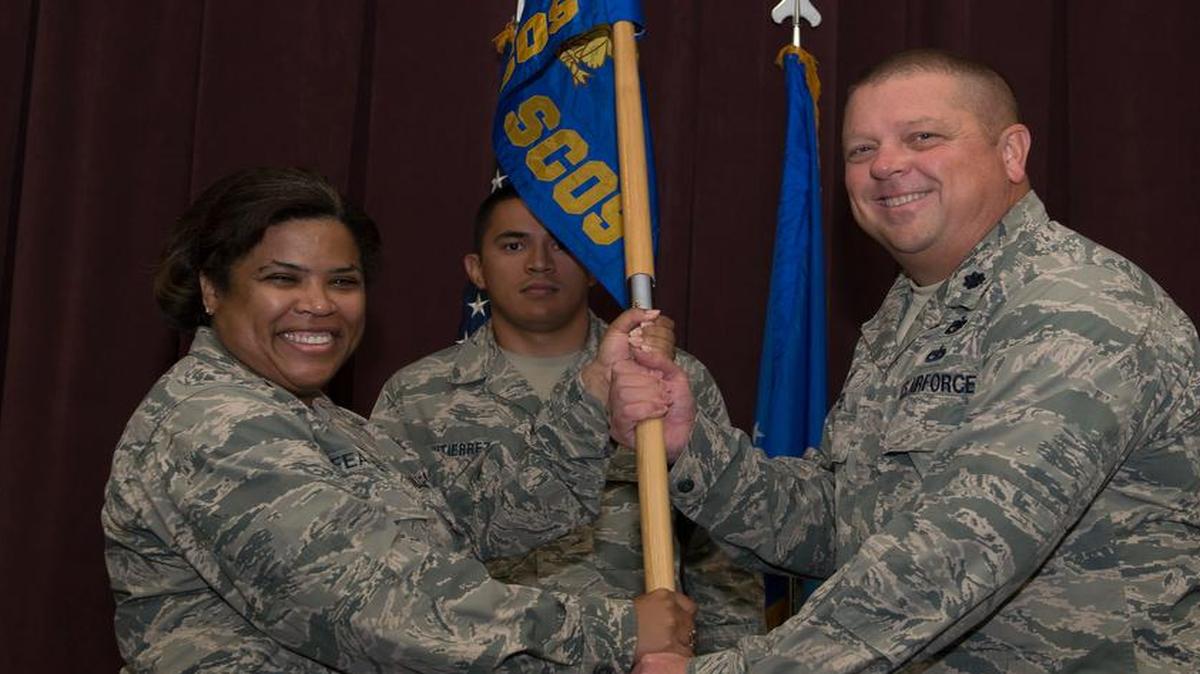 Lt. Col. Robert Lee assumes command July 7 of the 437th Supply Chain Operation Squadron and accepts the guidon from Col. Hilary Feaster, Air Force Sustainment Center deputy director of logistics.