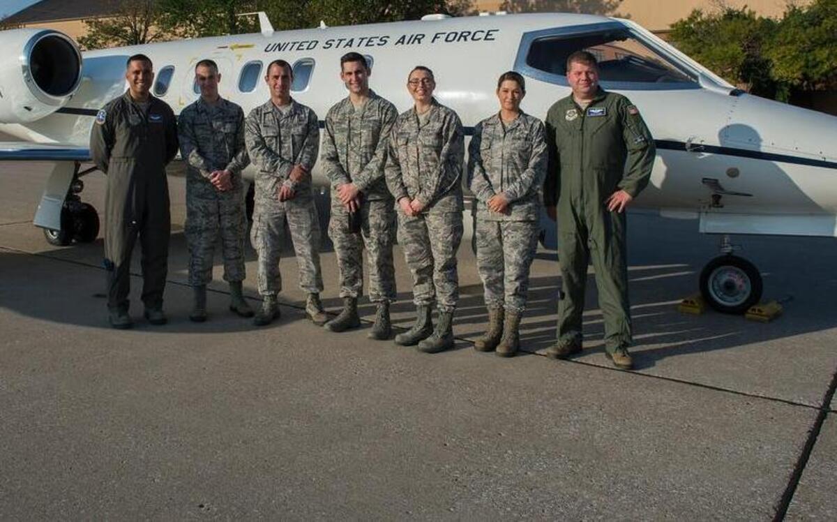 458th Airlift Squadron pilots and five Airmen pose in front of a C-21 prior to an incentive flight departing Scott. The Airmen rewarded with this incentive flight were from around the base who showed hard work and dedication.
