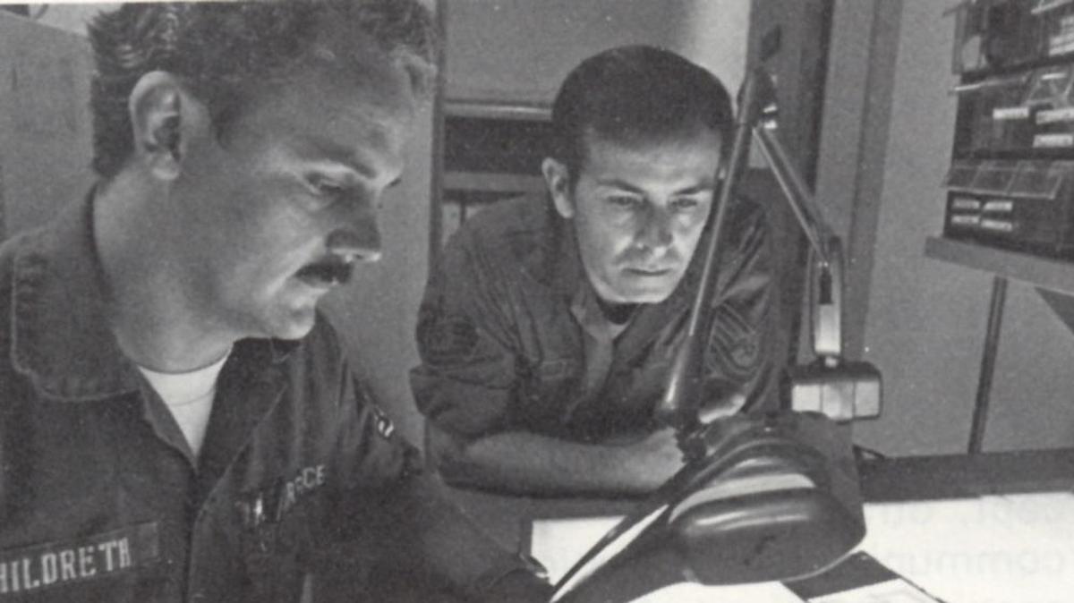 Members of the 1842nd Electronics Engineering Group review circuit board negatives at Scott Air Force Base.