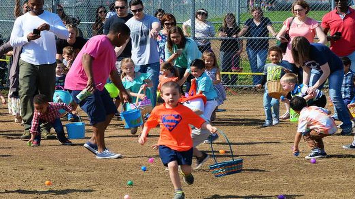 Egg hunters dash off to collect as many eggs as they can at the Egg Hunt Egg-Stravaganza on April 15 at Scott. The 375th Force Support Squadron hosted the free event at the Scott AFB Youth Center. It included egg hunts for different age groups, Easter bunny, bounce houses, face painting, prizes, food from the USO, sack races, and a Security Forces and fire truck vehicle display. In addition, members of the 375th SFS talked to crowds of families about their jobs and let children see what it was like to sit inside their various vehicles.