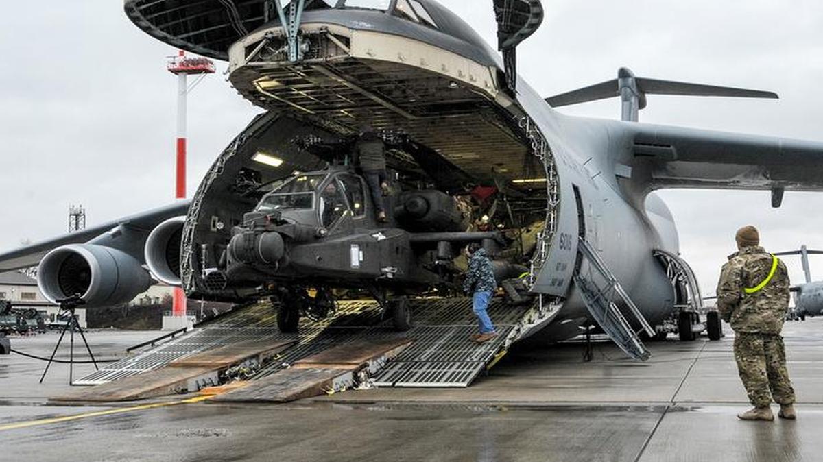 An Army AH-64 Apache helicopter is unloaded from an Air Mobility Command C-5M Galaxy at Ramstein Air Base, Germany, in support of Operation Atlantic Resolve. The four Apache helicopters that arrived were part of a larger contingent of helicopters and personnel contributing to Operation Atlantic Resolve, a U.S. commitment to maintaining peace and stability in the European region.