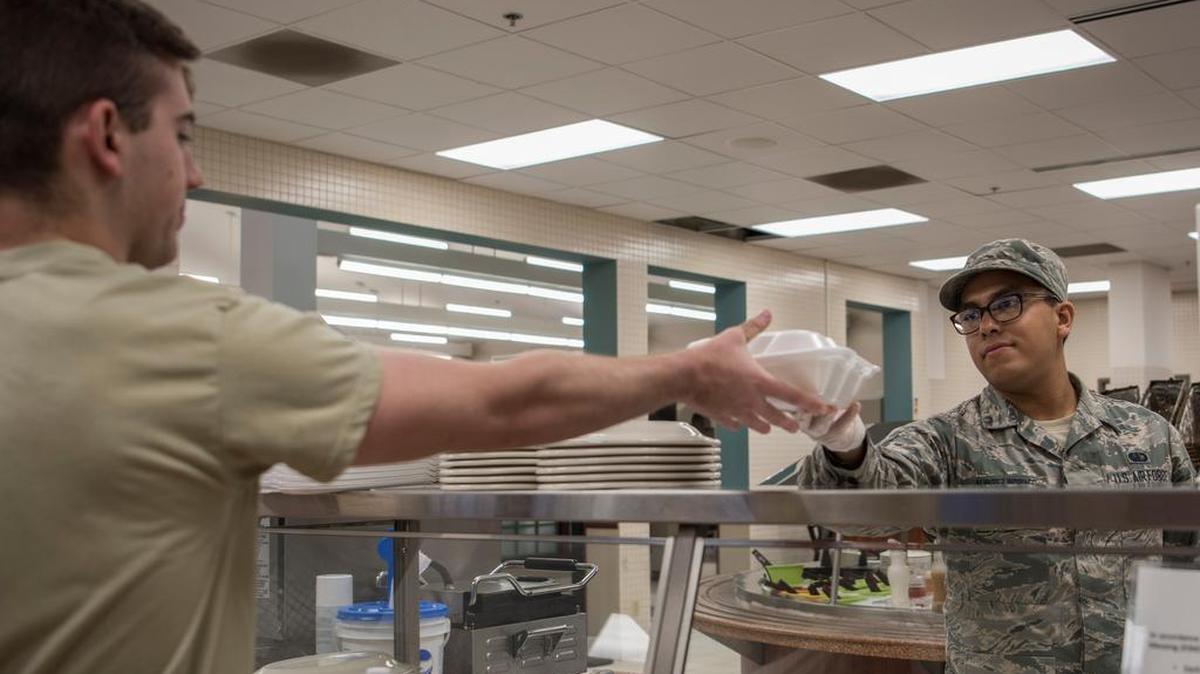 Airman 1st Class Gabriel Alvarez Indriago, 375th Force Support Squadron food service technician, serves a meal at the Nightingale Dining Facility June 25 at Scott Air Force Base. The dining facility will be closed until the end of November to complete the renovations for the Food 2.0 initiative.