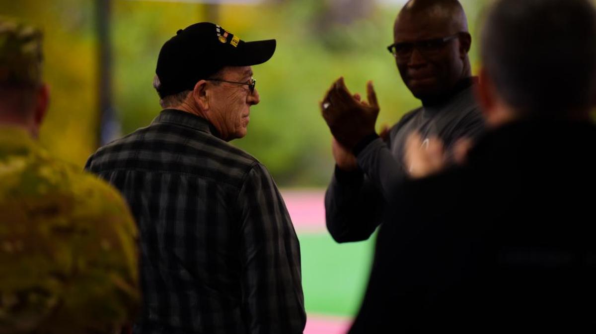 Roger “Red” Darden, a Vietnam War Veteran, stands up during the opening ceremony for the Air Force Sergeant’s Association 9th Annual Veteran’s Vigil Run on Nov. 2 at the James Gym Track at Scott Air Force Base. Darden was the honoree for the vigil run, while fellow Vietnam War Veteran Jack Poltras also attended the event. During the war in 1968, Darden and his unit were on a 42-day search and destroy mission upon which they were approaching Can Tho Airfield in South Vietnam, which was under attack. Darden noticed a dredge pipe in which the Viet Cong were entering from. After making it to the end of the pipe he noticed two men lying in a ditch—one of those men was Poltras. Photo by Staff Sgt. Michael Cossaboom