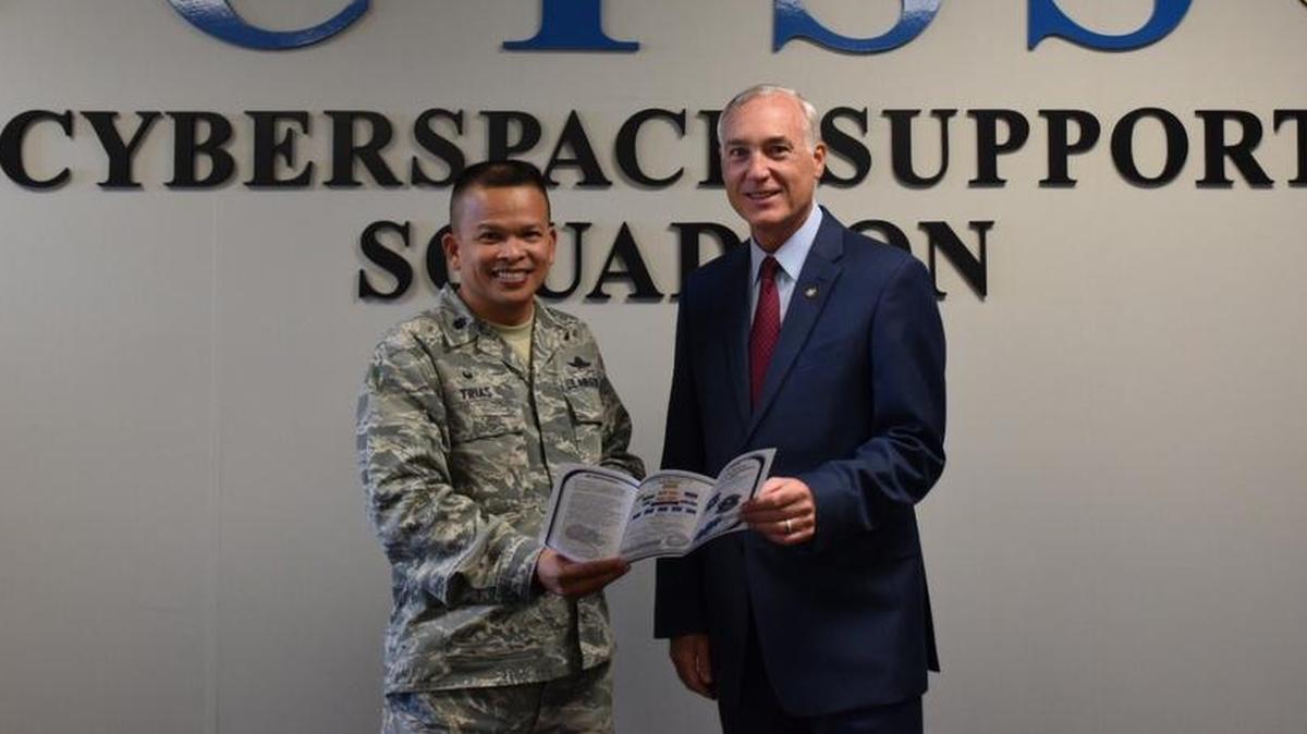 Lt. Col. Eric Trias, Cyberspace Support Squadron commander, and Scott Ferguson, Air Force Communications Security Field Support team lead, review communications security functions within the CYSS tri-fold.