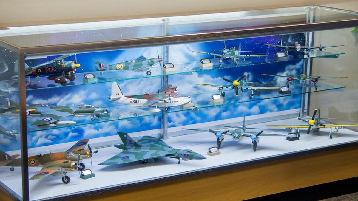A view of some of the model aircraft donated to the installation by Wayne Boller during a ceremony April 11 at Scott Air Force Base’s Airfield Management Operations Atrium. Boller donated 35 military aircraft models from the U.S., Germany, France and the United Kingdom. Staff. Sgt. Justin Baggett, 375th Operations Support Squadron, hand painted backdrops for each of the display cases showcasing the models.