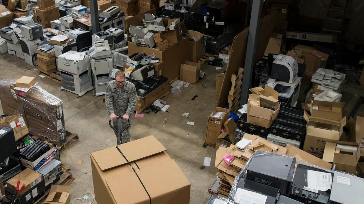 Staff Sgt. Zachary Livingston, 375th Communications Squadron alternate equipment control officer, moves a box of computer equipment in the base equipment control office at Scott Air Force Base. During the ITAM turn-in members of the 375th Air Mobility Wing and its tenant units were encouraged to turn in all the old and unused IT equipment.