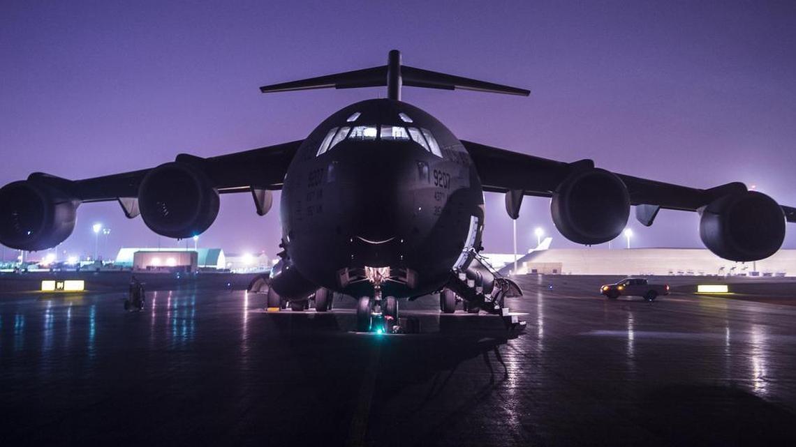 An Air Force C-17 Globemaster III sits on a ramp at Al Udeid Airbase, Qatar, before conducting combat airlift operations for U.S. and coalition forces in Syria in support of Operation Inherent Resolve.