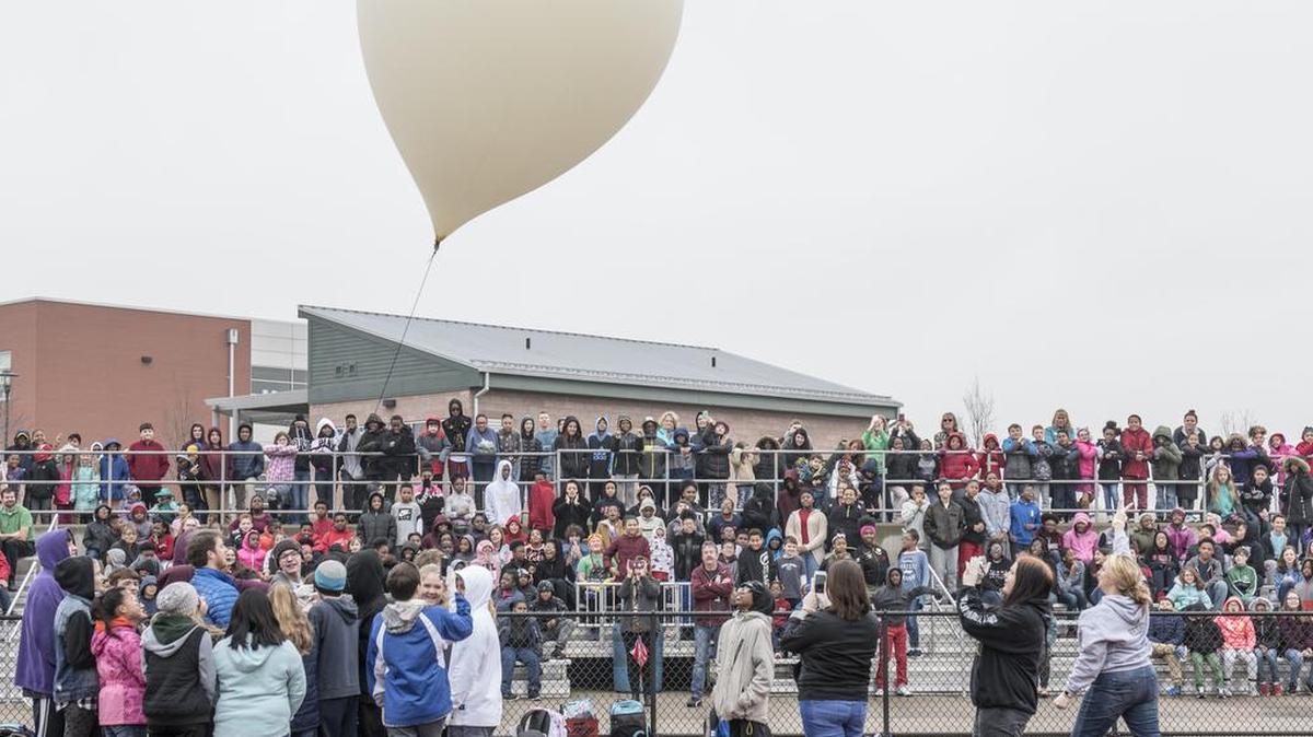 Approximately 650 students watch as eighth graders execute their year-long science, technology, engineering, and mathematics project made possible through an Air Force STEM grant Nov. 30 in Belleville. Three schools—Emge Junior High School, Smithton Middle School and Belle Valley School—worked together to launch a balloon that carried a high-altitude computer, which analyzed data ranging from altitude and coordinates traveled to temperature and pressure. The students found the popped balloon 140 miles away in Mount Carmel, Illinois.